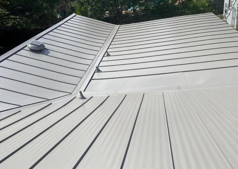 Solar attic fan installed on a metal roof for Roof Ventilation in Campton Hills